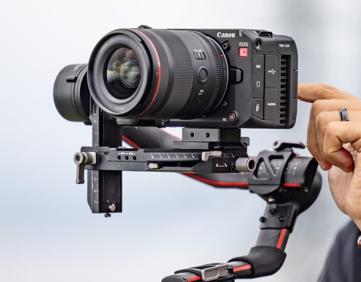 D227 lifestyle, male using camera with top handle and L340 outdoors on gimbal